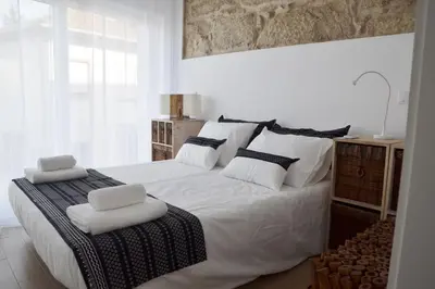 a bedroom with a large white bed with white pillows at Portoo Blue Apartments - Amazing in Vila Nova de Gaia