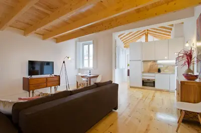 a living room with a couch and a piano at APOSENTUS - Clerigos Tower view Mezzanine in Porto