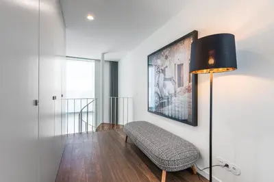 a living room with a chair and a lamp at Marques Design Apartments in Porto