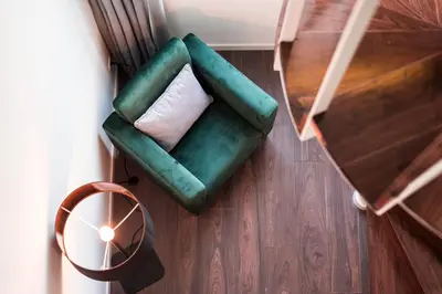 a green couch with a white pillow and a table at Marques Design Apartments in Porto