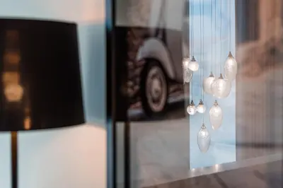 a group of lights hanging from a glass window at Marques Design Apartments in Porto
