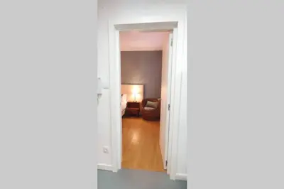 an open door to a living room with a couch at T2P Mimosa House in Vila Nova de Gaia