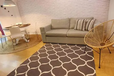 a living room with a couch and a table at T2P Mimosa House in Vila Nova de Gaia