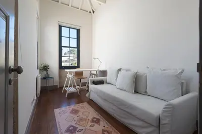 a living room with a white couch and a table at Porto Garden Villa in Porto