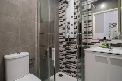 a bathroom with a toilet and a sink and a shower at Moreira 284 in Porto