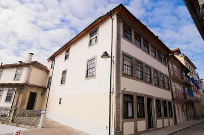 a white building with a street light in front of it at OportoLuxApartments in Porto