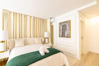 a bedroom with a bed with a towel on it at OportoLuxApartments in Porto