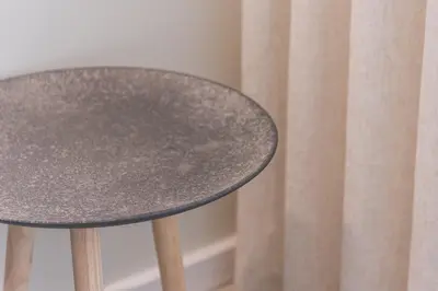 a table next to a curtain at River View Building in Vila Nova de Gaia