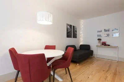 a living room with a table and chairs and a couch at Heart of D Pedro Apartments in Porto