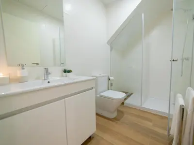 a bathroom with a sink and a toilet and a shower at Ponte D Luis I Apartments in Porto