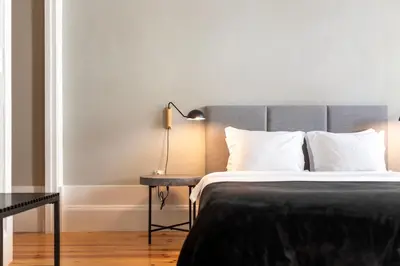 a bedroom with a bed and a lamp on a table at Cedofeita Premium Apartment 1F in Porto