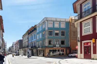 a tall blue building on a city street at Cedofeita Premium Apartment 1B in Porto