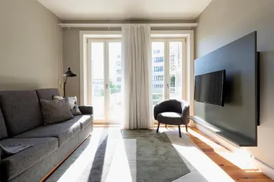 a living room with a couch and a tv at Cedofeita Premium Apartment 1B in Porto