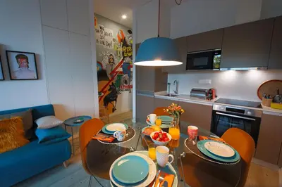 a kitchen and living room with a table and chairs at Art District - POP & ROCK Apartments in Porto