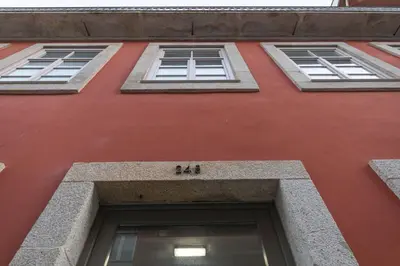 a red building with four windows on it at Art District - POP & ROCK Apartments in Porto