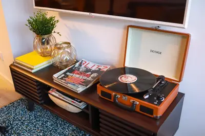 a table with a record player and a mirror at Art District - POP & ROCK Apartments in Porto