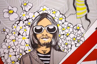 a drawing of a man with sunglasses and flowers at Art District - POP & ROCK Apartments in Porto