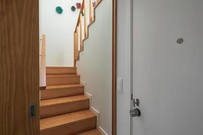 a hallway with wooden stairs next to a door at Kings Oporto Apartments in Porto