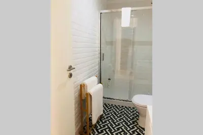 a bathroom with a toilet and a glass shower at CL Freixo Apartment in Porto
