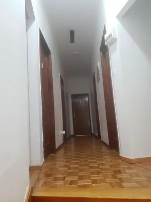 an empty hallway with two doors and a wooden floor at Truz truz2 in Porto