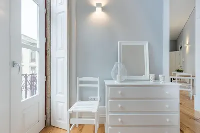 a white dresser in a room with a window at LovelyStay - Porto Windows with AC by central station in Porto