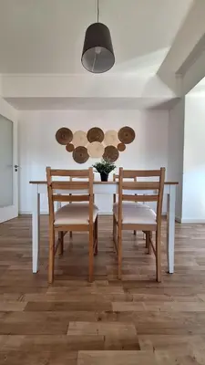 a dining room and living room with a table and chairs at Apartamentos Jardim do Morro in Vila Nova de Gaia