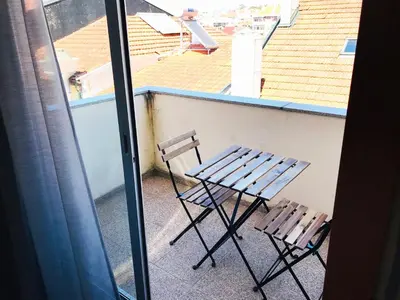 a table and two chairs sitting on a balcony at Azulejos Apartment in Porto