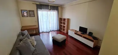 a living room with a couch and a television at Azulejos Apartment in Porto