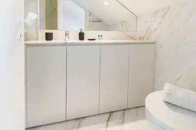 a white bathroom with a sink and a mirror at MSC Flat 8 in Porto