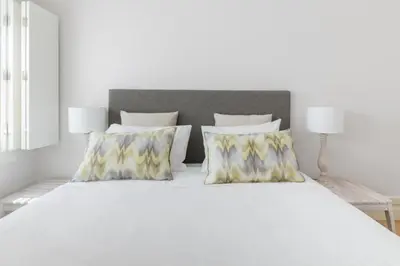 a bedroom with a white bed with two pillows at MSC Flat 8 in Porto