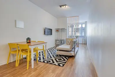 a dining room with a yellow table and a chair at Travel & live Santa Catarina apartment in Porto