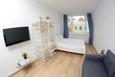 a living room with a white book shelf and a couch at Travel & live Santa Catarina apartment in Porto