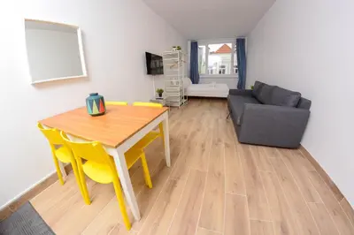 a living room with a table and a couch at Travel & live Santa Catarina apartment in Porto