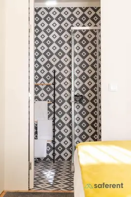 a bedroom with a bed and a black and white wall at Light-filled Bonjardim Apartments in Porto