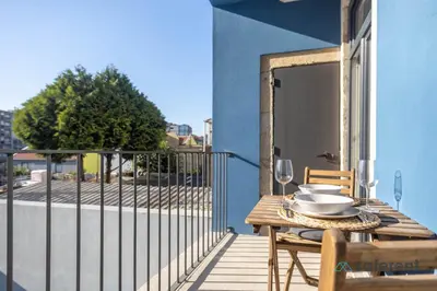 a table with a plate of food on a balcony at Light-filled Bonjardim Apartments in Porto