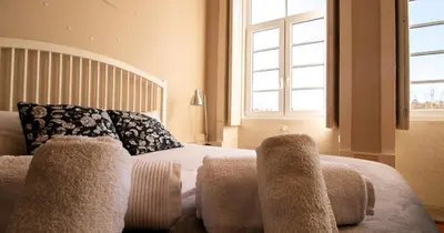 a bedroom with a bed with two pillows on it at Casa do Recanto in Porto