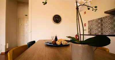 a table with a plate of food and a plant at Casa do Recanto - Loft vista rio in Porto