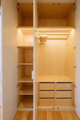 a closet with white walls and wooden shelves at BOUTIQUE Rentals- THE RIBEIRA***** Apt great views in Porto