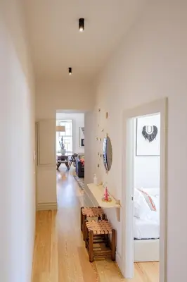 a white room with a bed and a bench at BOUTIQUE Rentals- THE RIBEIRA***** Apt great views in Porto