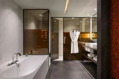 a bathroom with a tub and a sink and a shower at Forte de Gaia, Autograph Collection in Vila Nova de Gaia