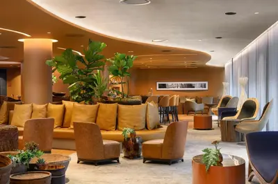 a lobby with a couch and chairs and tables at Forte de Gaia, Autograph Collection in Vila Nova de Gaia