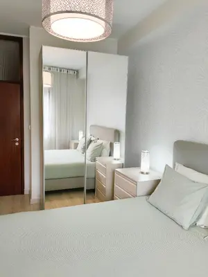 a bedroom with a bed and a large mirror at Porto Santa Catarina - Apartment with Terrace in Porto