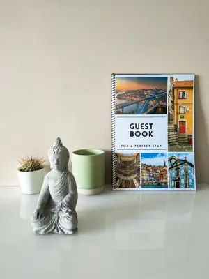 a book and a statue sitting on a table next to a book at Porto Santa Catarina - Apartment with Terrace in Porto