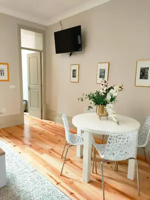 a white dining room with a white table and chairs at Porto Unique - Apartment with Private Patio in Porto