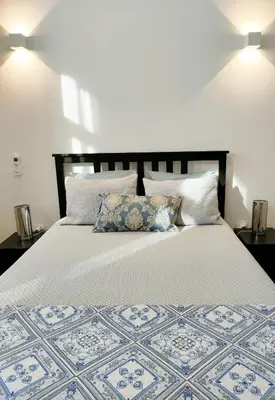 a bedroom with a large white bed with pillows at Porto Unique - Apartment with Private Patio in Porto