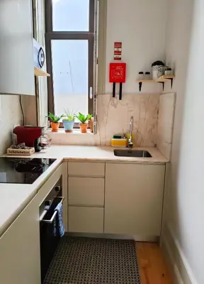 a small kitchen with a sink and a window at Porto Unique - Apartment with Private Patio in Porto