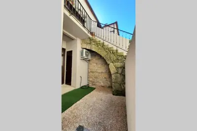 a staircase leading up to a house with a stone wall at Porto Unique - Apartment with Private Patio in Porto