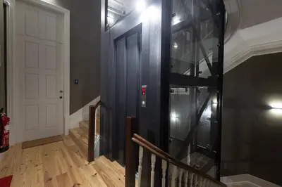 a staircase with a glass elevator in a house at Fashion Luxury House in Porto