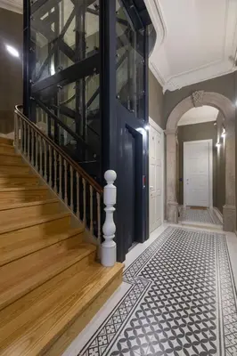 a hallway with a blue door and wooden stairs at Fashion Luxury House in Porto