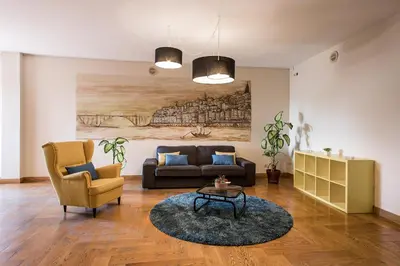 a living room with a couch and a table at Vilar Oporto Hotel in Porto